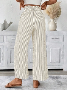 Detail of high waist striped trousers showing the paperbag elastic waist and linen texture