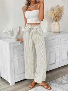 Detail of high waisted striped wide leg trousers with a soft drawstring waistband