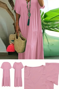 Detailed close-up of pink V-neck dress showing fabric texture and tiered ruffle hem
