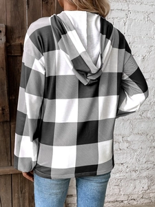 Rear view of a black and white buffalo plaid hooded sweatshirt in a relaxed casual style