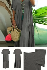 Detail view of a V-neck dark grey summer dress with layered tiered hem and fabric texture