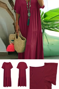 Detail view of wine red tiered dress with V-neckline and textured lightweight fabric