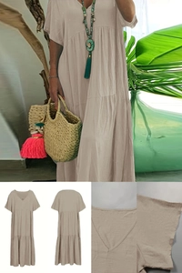 Detail of V-neck tiered beige cotton maxi dress with short sleeves and flowy silhouette