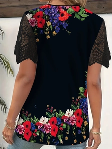 Back view of floral print top with intricate black lace patchwork sleeves and crew neck