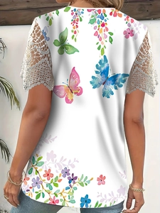 Detail of colorful butterfly print and white lace patchwork sleeve on a summer tee