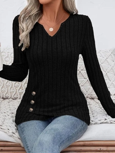 Detail of ribbed knit top featuring V-neck and three decorative side buttons on the hem