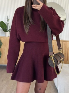 Close-up of burgundy knitted two-piece set featuring thick fabric and woven texture