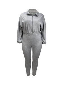 Detailed close-up of grey two-piece tracksuit featuring zipper jacket and slim-fit pants