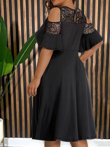 Detail of elegant black plus size dress featuring floral lace and cold shoulder cutouts