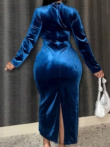 Rear view detail of a royal blue velvet maxi dress showing the slit hem and slim fit