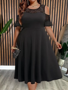 Detail of elegant lace patchwork and cold shoulder cutout on a black plus size dress