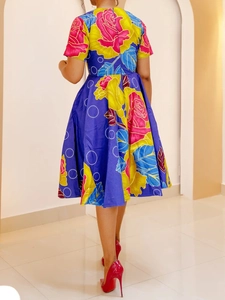 Detail of vibrant rose print A-line dress with short sleeves and a smooth back zipper