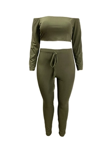 Detail of olive green ribbed knit fabric and drawstring waist on high-waist pants
