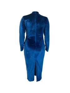 Detail view of the back zipper and slit on a deep blue velvet long sleeve dress