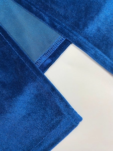 Detailed close-up showing the professional stitching and texture of blue velvet fabric