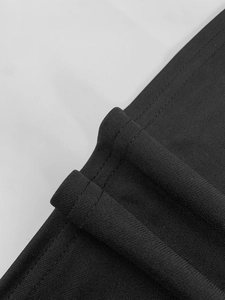 Detail of high-quality double-needle stitching on premium black lace dress fabric