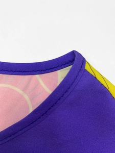 Close-up detail of double-needle stitching and print on a purple and pink dress neck