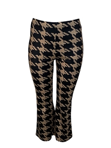 Detailed close-up of high-waist flared pants featuring a classic yellow houndstooth pattern