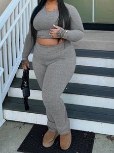 Chic grey two-piece lounge set with long sleeve crop top and slim-fit matching pants