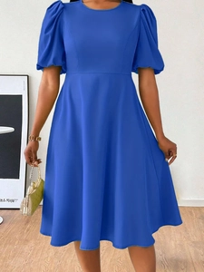Detailed view of puff sleeves and round neckline on this royal blue midi dress