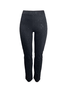 Detail of high-waisted black slim pants featuring shimmering silver sequins and star-like texture