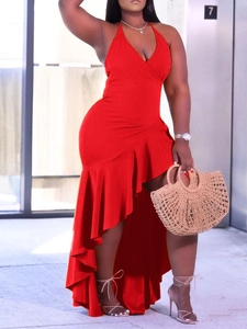 Detail of red halter neck dress featuring deep V-neck and ruffled high-low hemline