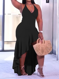 Detail of a black sleeveless halter neck dress with asymmetric ruffled hem and V-neckline