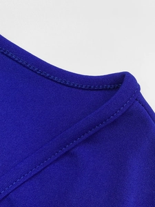 Détail de la couture à double aiguille sur le tissu de la robe bleue royale à col V