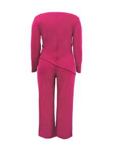 Detail of fuchsia two-piece set with long sleeve top featuring asymmetric hem and wide pants