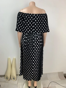Detail view showing the back of a black and white polka dot pleated maxi dress for women