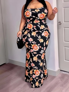 Close-up of the vintage orange and pink floral pattern on a slim-fit black maxi dress