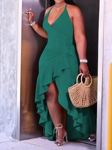 Detail of emerald green halter dress featuring asymmetrical ruffled hem and side drawstring