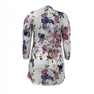 Detail view of the floral butterfly print on women's white long sleeve top from the back