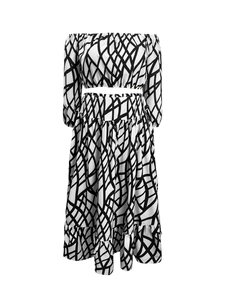 Detailed view of the layered ruffle hem on geometric grid print maxi skirt