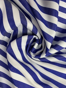 Macro shot of blue and white striped fabric texture with elegant spiral draping