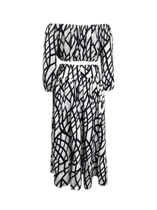 Back view of elegant two-piece set featuring off-shoulder top and grid pattern maxi skirt