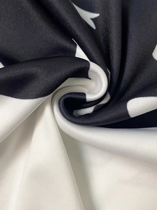 Detailed macro view of soft synthetic fabric with black and white star pattern