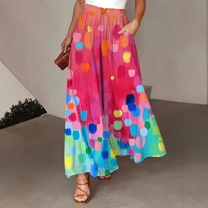 Detail of colorful high-waisted wide-leg trousers with vibrant abstract brushstroke patterns