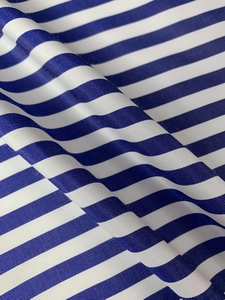 Close-up of blue and white striped fabric showing fine textile texture and soft waves