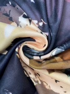 Detail of floral print fabric showing abstract patterns and soft textured knit material