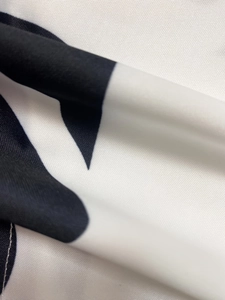 Macro shot of breathable black and white patterned fabric texture for casual summer set