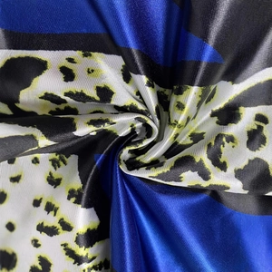 Detailed macro view of the glossy satin fabric with blue, black and leopard print patterns