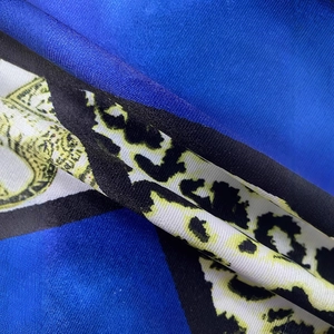 Detailed view of the leopard print fabric with silky texture and blue geometric patterns