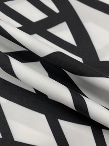 Macro shot of modern black and white geometric textile fabric with a smooth polished texture