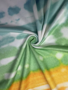 Detailed close-up of vibrant tie-dye fabric with soft knit texture and spiral fold pattern
