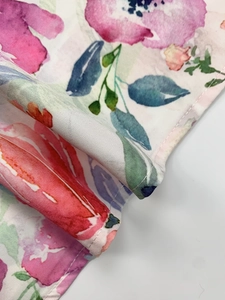 Detailed macro view of watercolor floral print on high-quality twill cotton fabric