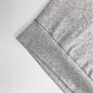 Gros plan sur la texture en tricot gris et les coutures soignées de l'ensemble 3 pièces