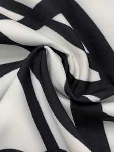 Detail shot showing the soft texture and black and white geometric pattern of the fabric
