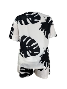 Casual two-piece summer set featuring black and white tropical monstera leaf print shorts and top