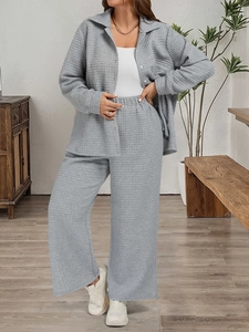 Women's two-piece grey waffle knit lounge set with button-down shirt and wide-leg trousers
